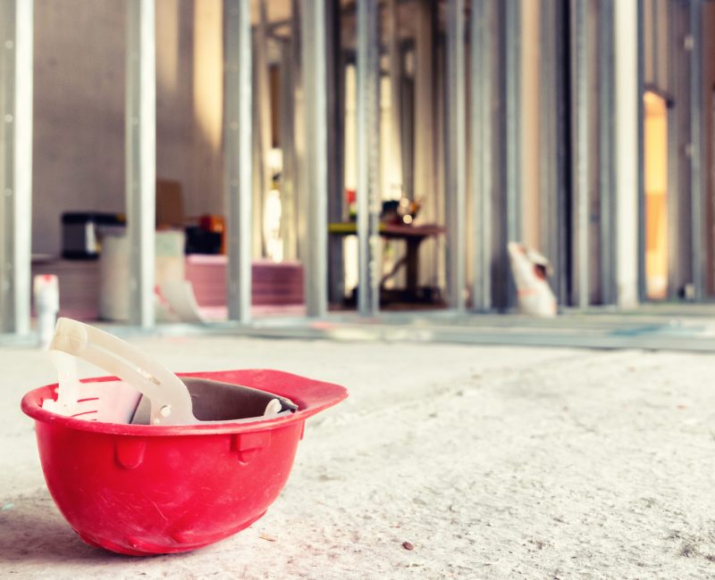 Red helmet on the ground at construction site